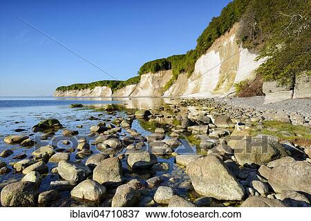Large stones on the shore of the Baltic Sea in front of the chalk cliffs of the cliffs, Jasmund National Park, Rügen Island, Mecklenburg-Western Pomerania, Germany, Europe View Large Photo Image Stock Photo - Large stones on the shore of the Baltic Sea in front of the chalk cliffs of the cliffs, Jasmund National Park, Rügen Island, Mecklenburg-Western Pomerania, Germany, Europe. Fotosearch