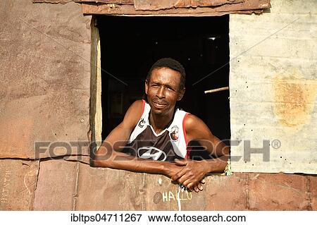 Local man looking out of the window of his poor corrugated iron hut, Spitzkoppe, Erongo region, Damaraland, Namibia, Africa View Large Photo Image Stock Photo - Local man looking out of the window of his poor corrugated iron hut, Spitzkoppe, Erongo region, Damaraland, Namibia, Africa. Fotosearch