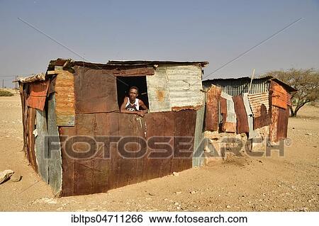 Local man looks out of the window of his poor corrugated iron hut, Spitzkoppe, Erongo region, Damaraland, Namibia, Africa View Large Photo Image Stock Photograph - Local man looks out of the window of his poor corrugated iron hut, Spitzkoppe, Erongo region, Damaraland, Namibia, Africa. Fotosearch