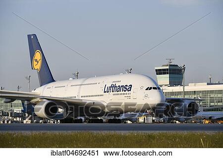 Lufthansa, Airbus, A380-800, with Push Back Truck towing from position to taxiway in front of satellite building (Terminal 2), evening mood, Munich Airport, Upper Bavaria, Bavaria, Germany, Europe View Large Photo Image Stock Image - Lufthansa, Airbus, A380-800, with Push Back Truck towing from position to taxiway in front of satellite building (Terminal 2), evening mood, Munich Airport, Upper Bavaria, Bavaria, Germany, Europe. Fotosearch