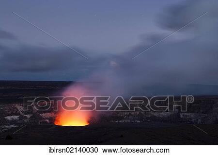 Stock Image - Magma in the Halema'uma'u Crater in the Kilauea Caldera illuminating the rising sulfur dioxide plume against the evening sky, Hawai'i Volcanoes National Park, Hawai'i, USA, North America. Fotosearch
