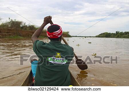 Malagasy, tour leader in a dugout boat, Madagascar, Africa View Large Photo Image Picture - Malagasy, tour leader in a dugout boat, Madagascar, Africa. Fotosearch