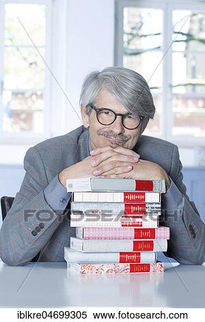 Man leaning on a book pile View Large Photo Image Stock Photography - Man leaning on a book pile. Fotosearch