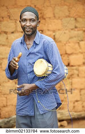 Picture - Man playing a traditional musical instrument, Bamenda, Cameroon, Africa. Fotosearch