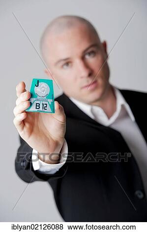 Stock Photo - Man presenting Austrian road tax vignette 2012. Fotosearch