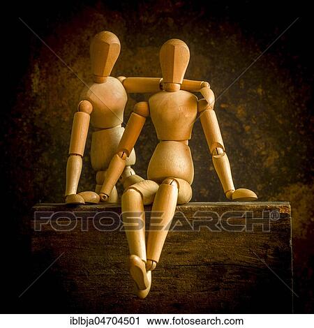Stock Image - Mannequins on a wooden box, studio shot, still. Fotosearch