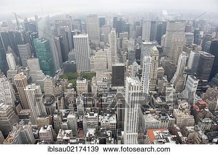 Metropolis, sea of houses, view from the Empire State Building to the skyscrapers of Midtown in fog, skyscrapers, Manhattan, New York City, USA, North America, America, North America View Large Photo Image Stock Photo - Metropolis, sea of houses, view from the Empire State Building to the skyscrapers of Midtown in fog, skyscrapers, Manhattan, New York City, USA, North America, America, North America. Fotosearch