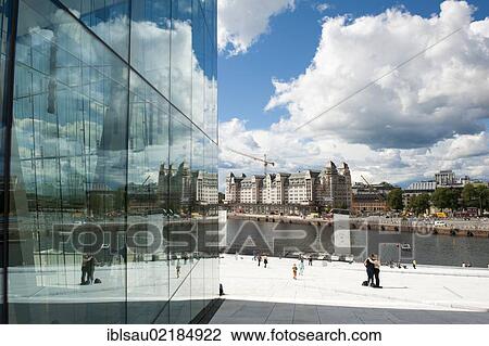 Stock Image - Modern architecture, clouds reflecting in glass facade, opera, Operaen, new opera house, Oslo, Norway, Scandinavia, Northern Europe, Europe. Fotosearch