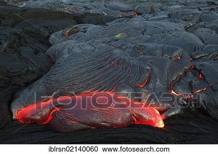 Stock Image - Molten pahoehoe type lava flowing from a crack in the East Rift Zone towards the sea, lava field of the Kilauea shield volcano, Hawai'i Volcanoes National Park, Kalapana, Hawai'i, USA, North America. Fotosearch