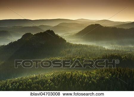 Stock Photo - Morning atmosphere in the Elbe Sandstone Mountains, view of the Lorenzsteine against the light, fog rises, Saxon Switzerland National Park, Saxony, Germany, Europe. Fotosearch
