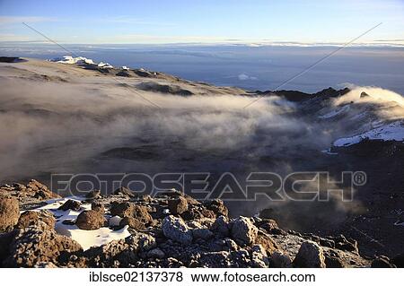 Morning fog in the crater of Mount Kilimanjaro, Tanzania, Africa View Large Photo Image Stock Photo - Morning fog in the crater of Mount Kilimanjaro, Tanzania, Africa. Fotosearch