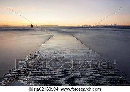 Picture - Morning mood with a road into Lake Constance at Hoernle, Baden-Wuerttemberg, Germany, Europe. Fotosearch