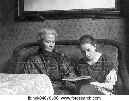 Stock Photograph - Mother and daughter reading a book, 1930s, Germany, Europe. Fotosearch