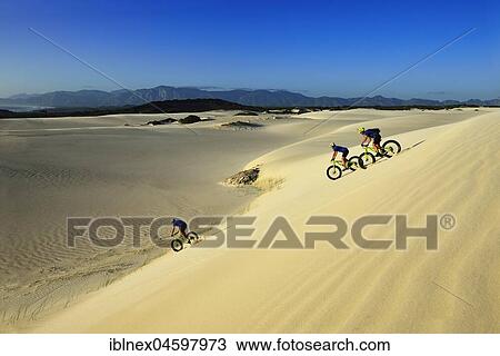 Mountain bikers with fat bikes descending sand dunes, cycling, Nature Reserve, De Kelders, Gansbaai, Western Cape, South Africa, Africa View Large Photo Image Stock Image - Mountain bikers with fat bikes descending sand dunes, cycling, Nature Reserve, De Kelders, Gansbaai, Western Cape, South Africa, Africa. Fotosearch