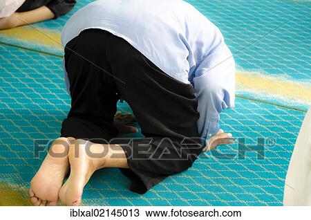 Stock Image - Muslim at prayer, Kuala Lumpur, Malaysia, Southeast Asia, Asia. Fotosearch