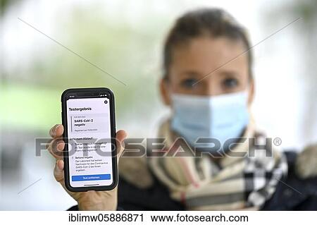 Negative test result, woman with face mask, showing smartphone with Corona Warn-APP, Corona crisis, Stuttgart, Baden-Württemberg, Germany, Europe View Large Photo Image Stock Image - Negative test result, woman with face mask, showing smartphone with Corona Warn-APP, Corona crisis, Stuttgart, Baden-Württemberg, Germany, Europe. Fotosearch
