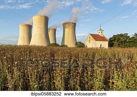 Stock Image - Old abandoned chapel and cooling towers of Dukovany Nuclear Power Station, Czech Republic, Europe. Fotosearch