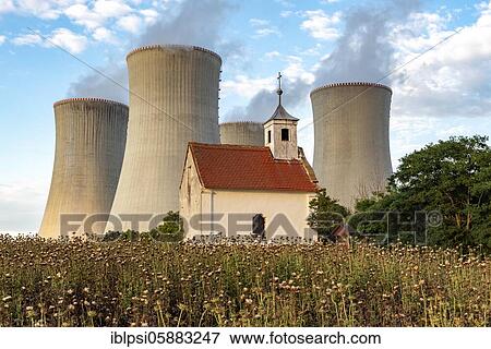 Stock Photo - Old abandoned chapel and cooling towers of Dukovany Nuclear Power Station, Czech Republic, Europe. Fotosearch