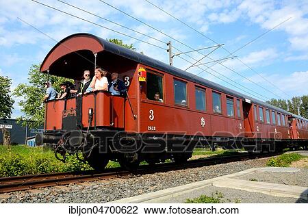 Stock Image - Old passenger railway wagon, built in 1931, with passenger on his way to Ystad, Scania, Sweden, Europe. Fotosearch