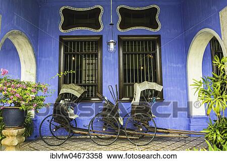 Old rickshaws on the blue wall, Cheong Fatt Tze Mansion, blue villa, Leith Street in George Town, Penang, Malaysia, Asia View Large Photo Image Stock Photo - Old rickshaws on the blue wall, Cheong Fatt Tze Mansion, blue villa, Leith Street in George Town, Penang, Malaysia, Asia. Fotosearch