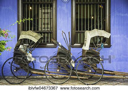 Old rickshaws on the blue wall, Cheong Fatt Tze Mansion, blue villa, Leith Street in George Town, Penang, Malaysia, Asia View Large Photo Image Stock Photo - Old rickshaws on the blue wall, Cheong Fatt Tze Mansion, blue villa, Leith Street in George Town, Penang, Malaysia, Asia. Fotosearch