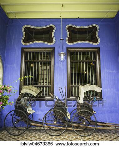 Old rickshaws on the blue wall, Cheong Fatt Tze Mansion, blue villa, Leith Street in George Town, Penang, Malaysia, Asia View Large Photo Image Stock Photograph - Old rickshaws on the blue wall, Cheong Fatt Tze Mansion, blue villa, Leith Street in George Town, Penang, Malaysia, Asia. Fotosearch