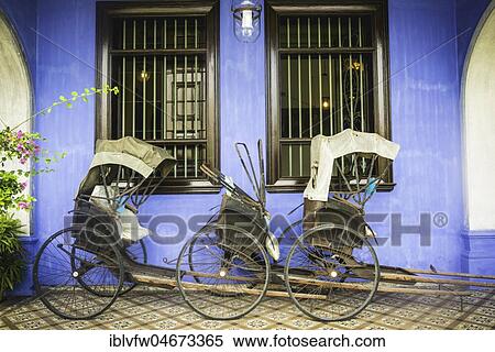 Old rickshaws on the blue wall, Cheong Fatt Tze Mansion, blue villa, Leith Street in George Town, Penang, Malaysia, Asia View Large Photo Image Stock Photography - Old rickshaws on the blue wall, Cheong Fatt Tze Mansion, blue villa, Leith Street in George Town, Penang, Malaysia, Asia. Fotosearch