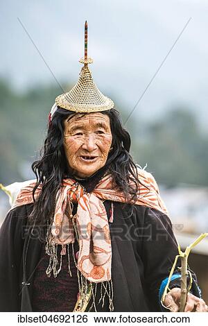 Stock Photograph - Old woman with traditional hat of the mountain people of the Laya, Gasa district, Himalaya region, Bhutan, Asia. Fotosearch