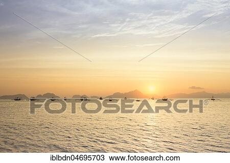 Outrigger canoes at sunset, view from Corong Corong beach near El Nido, Bacuit archipelago, Palawan island, Philippines, Asia View Large Photo Image Stock Image - Outrigger canoes at sunset, view from Corong Corong beach near El Nido, Bacuit archipelago, Palawan island, Philippines, Asia. Fotosearch