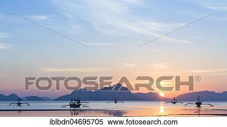 Outrigger canoes at sunset, view from Corong Corong beach near El Nido, Bacuit archipelago, Palawan island, Philippines, Asia View Large Photo Image Stock Photography - Outrigger canoes at sunset, view from Corong Corong beach near El Nido, Bacuit archipelago, Palawan island, Philippines, Asia. Fotosearch