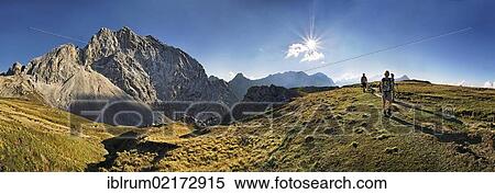 Stock Photography - Panoramic view, hikers walking on the trail to Meilerhuette mountain lodge, Partenkirchener Dreitorspitze mountain range, Garmisch-Partenkirchen, Wetterstein mountain range, Bavaria, Germany, Europe. Fotosearch