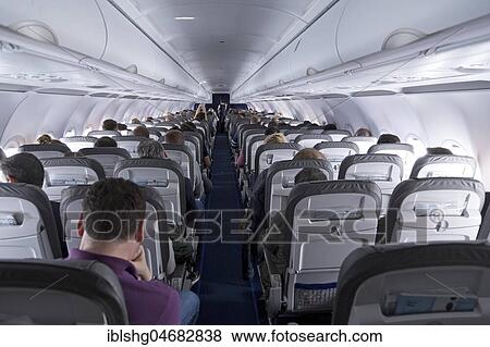 Passengers in a passenger plane during flight View Large Photo Image Stock Photo - Passengers in a passenger plane during flight. Fotosearch