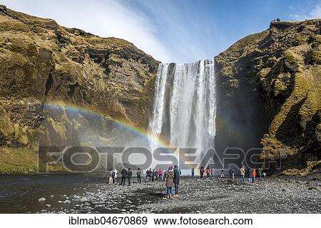 People at the waterfall Skogafoss with rainbow, Skogar, South Iceland, Iceland, Europe View Large Photo Image Stock Photo - People at the waterfall Skogafoss with rainbow, Skogar, South Iceland, Iceland, Europe. Fotosearch