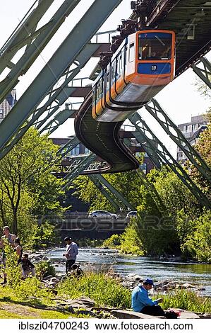 People on the river Wupper with moving suspension railway over it, Wuppertal, Bergisches Land, North Rhine-Westphalia, Germany, Europe View Large Photo Image Stock Image - People on the river Wupper with moving suspension railway over it, Wuppertal, Bergisches Land, North Rhine-Westphalia, Germany, Europe. Fotosearch