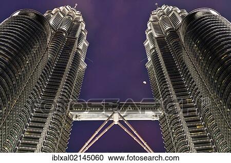 Stock Image - Petronas Towers at night with moon, skybridge, Kuala Lumpur, Malaysia, Southeast Asia, Asia. Fotosearch