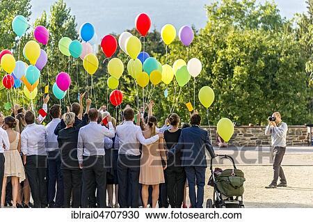 Stock Image - Photographer takes photos of a festive gathering with colourful balloons, Bad Homburg vor der Höhe, Hesse, Germany, Europe. Fotosearch