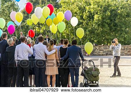 Stock Photo - Photographer takes photos of a festive gathering with colourful balloons, Bad Homburg vor der Höhe, Hesse, Germany, Europe. Fotosearch