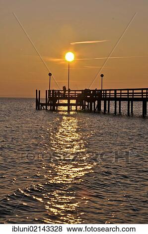 Stock Photo - Pier at sunset on the Baltic Sea, Neustadt in Holstein, Neustadt Bay, Baltic Sea, Schleswig-Holstein, Germany, Europe. Fotosearch