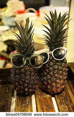 Stock Photo - Pineapple with sunglasses, Yum Cha Restaurant, Hong Kong, China, Asia. Fotosearch