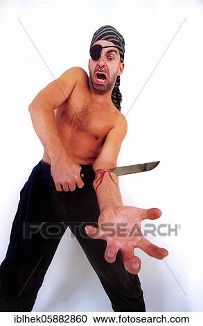 Stock Image - Pirate parting with a knife in his arm, eye patch, nose ring, Berlin, Germany, Europe. Fotosearch