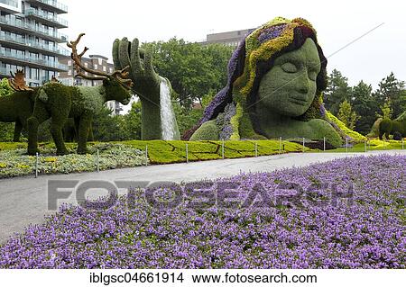 Plant sculpture Mother Earth with modern buildings behind, Mosaicanada Exhibition, Gatineau, Quebec Province, Canada, North America View Large Photo Image Picture - Plant sculpture Mother Earth with modern buildings behind, Mosaicanada Exhibition, Gatineau, Quebec Province, Canada, North America. Fotosearch