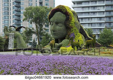 Stock Image - Plant sculpture Mother Earth with modern buildings behind, Mosaicanada Exhibition, Gatineau, Quebec Province, Canada, North America. Fotosearch