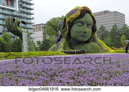 Plant sculpture Mother Earth with modern buildings behind, Mosaicanada Exhibition, Gatineau, Quebec Province, Canada, North America View Large Photo Image Stock Photograph - Plant sculpture Mother Earth with modern buildings behind, Mosaicanada Exhibition, Gatineau, Quebec Province, Canada, North America. Fotosearch