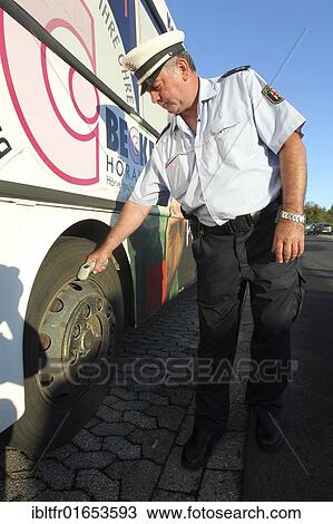 Police officer checking the tires of a school bus, Plaidt, Rhineland-Palatinate, Germany, Europe View Large Photo Image Stock Image - Police officer checking the tires of a school bus, Plaidt, Rhineland-Palatinate, Germany, Europe. Fotosearch