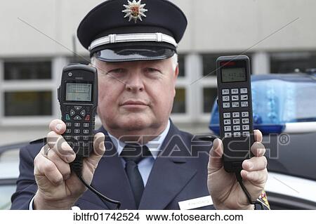Police officer displaying a new digital radio which is currently being tested by the Rhineland-Palatinate police, left, and the previous analog device, right, Koblenz, Rhineland-Palatinate, Germany, Europe View Large Photo Image Picture - Police officer displaying a new digital radio which is currently being tested by the Rhineland-Palatinate police, left, and the previous analog device, right, Koblenz, Rhineland-Palatinate, Germany, Europe. Fotosearch