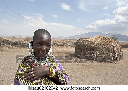 Portrait, ethnology, Maasai woman wearing jewellery, Maasai, in front of Hut made of Straw and branches, village of Kiloki, savannah, Ngorongoro Conservation Area, Serengeti National Park, Tanzania, East Africa, Africa View Large Photo Image Stock Image - Portrait, ethnology, Maasai woman wearing jewellery, Maasai, in front of Hut made of Straw and branches, village of Kiloki, savannah, Ngorongoro Conservation Area, Serengeti National Park, Tanzania, East Africa, Africa. Fotosearch
