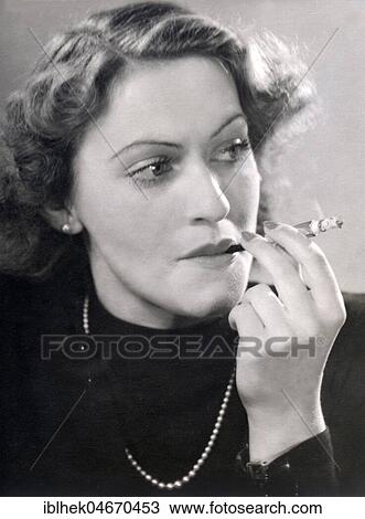 Portrait of a smoking woman with cigarette holder, 1940s, Germany, Europe View Large Photo Image Stock Image - Portrait of a smoking woman with cigarette holder, 1940s, Germany, Europe. Fotosearch