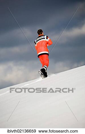 Rescuer showing the landing site to a helicopter, rescue operation with a rescue helicopter in the Thuringian Slate Mountains, Thuringia, Germany, Europe View Large Photo Image Stock Photo - Rescuer showing the landing site to a helicopter, rescue operation with a rescue helicopter in the Thuringian Slate Mountains, Thuringia, Germany, Europe. Fotosearch