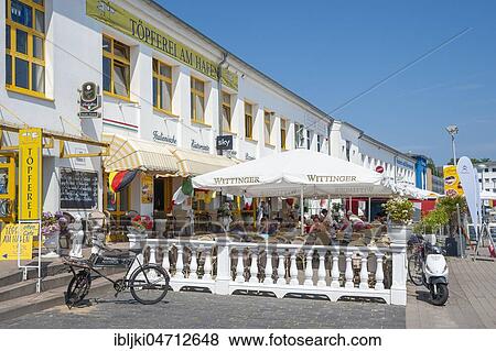 Stock Photo - Restaurant at the harbour promenade, Sassnitz, Rügen, Mecklenburg-Western Pomerania, Germany, Europe. Fotosearch