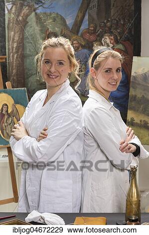 Stock Photo - Restoration atelier, Women, Restorers stand in front of restored Lent Scarf, Munich, Bavaria, Germany, Europe. Fotosearch